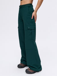 Model in green RecTrek Cargo Pant with cinchable hems and utility-style pockets, ready for active adventures.