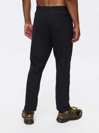 Back view of RecTrek Pant in Black, featuring a relaxed fit and zippered pockets for easy access.