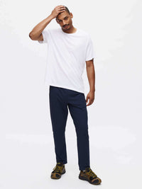 Model standing in relaxed pose wearing RecTrek Pant in Navy, featuring a drawstring waist and zippered pockets.