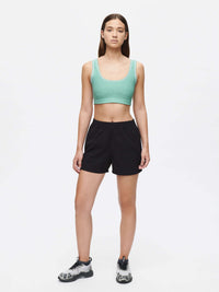 Model standing in RecTrek 4" Short in Black, featuring a comfortable pull-on design and zippered pocket.