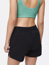 Back view of model wearing RecTrek 4" Short in Black, featuring a comfortable elastic waistband.