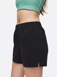 Side view of model wearing RecTrek 4" Short in Black, featuring a zippered pocket and relaxed fit.