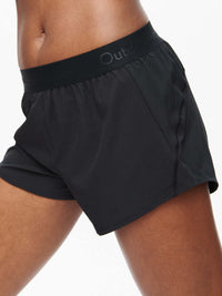 Side view of Relay 3" Short in Black, featuring a lightweight design and elastic waistband for activewear.