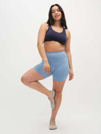 Model posing in Echo 5.5" Short in Cotton Candy, with the tall waistband and supportive stretch.
