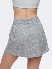 Back view of Warmup 2.5" Skort in Heather Grey, with its smooth and flexible design for active movement.