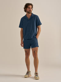 Model standing in SolarCool Camp Collar in Blue, lightweight and breathable fabric, for outdoor activities.
