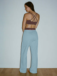 Model from the back wearing Sport Sweatpant in Blue, featuring a technical waistband for comfort.
