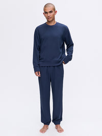 Model standing in Stratus Sweatpant in Navy, relaxed silhouette with heavyweight fabric, styled for lounging.