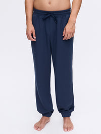 Model standing in Stratus Sweatpant in Navy, featuring a relaxed silhouette with adjustable drawstring waist.