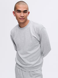 Model wearing Stratus Sweatshirt in Gray, featuring a relaxed silhouette for coziness and warmth.