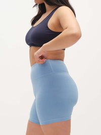 Model in profile wearing Echo 5.5" Short in Cotton Candy, featuring a high-rise waist and supportive stretch.
