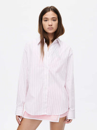 Model wearing a Striped Sun Shirt in lightweight cotton poplin, with subtle stripes and oversized fit.