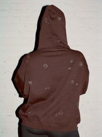 Back view of Sunny Hoodie in Brown, featuring playful graphic designs throughout the fabric.