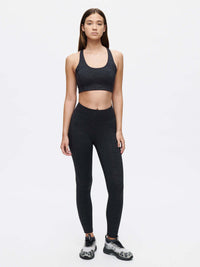 Model standing in TechSweat Core 7/8 Legging in Black, featuring a high waistband for secure fit during workouts.