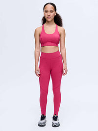 Model standing in TechSweat Core 7/8 Legging in Pink, featuring a supportive waistband for active movement.