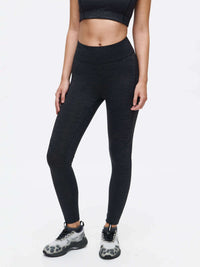 Model posing in TechSweat Core 7/8 Legging in Black, with a lightweight, breathable fabric for high-intensity workouts.