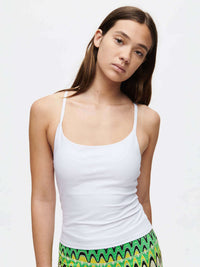 Model wearing TechSweat Move Free Tank in White, with adjustable racerback straps and a built-in shelf bra.