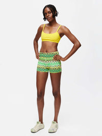 Model in TechSweat 3" Short with vibrant green pattern, built for performance and comfort.