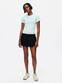 Model standing in ThinkFast Jersey Baby Tee in Light Blue, featuring a soft, technical fabric for everyday activities.