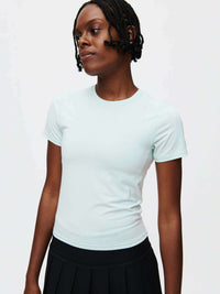 Model wearing ThinkFast Jersey Baby Tee in Light Blue, with high-stretch jersey fabric and a sleek fit.