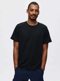 Model wearing ThinkFast Mesh Shortsleeve in Black with technical fabric and built-in cooling technology.