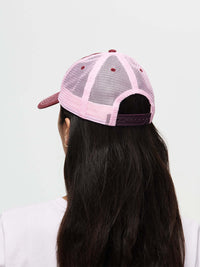 Back view of a stylish Doing Things trucker hat in pink, for outdoor activities.