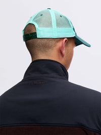 Back view of a person wearing Trucker Hat in Aqua, featuring adjustable straps and breathable mesh.
