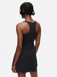 Back view of Volley Dress in Black, featuring a fit-and-flare silhouette and built-in shorts.
