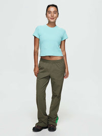 Model standing in relaxed pose wearing Waffle Baby Tee in Aqua, featuring a fitted crop design.