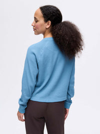 Back view of Waffle Longsleeve in Blue, with the soft waffle knit fabric and boxy fit.