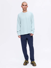 Model standing in relaxed pose, wearing Waffle Longsleeve in Light Blue, soft waffle knit fabric.