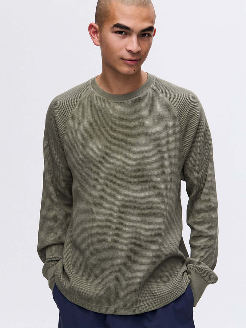 Model wearing Waffle Longsleeve in Olive, featuring a relaxed fit and soft waffle knit fabric.