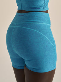 Back view of Warmup 5" Short in Bright Blue, featuring a sculpted fit and textured compression fabric.