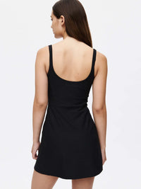 Back view of Warmup Dress in Black, featuring adjustable straps and a relaxed fit for activewear.