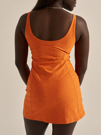 Back view of Warmup Dress in Bright Orange, with the fitted design and soft texture.