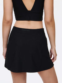 Back view of Warmup 2.5" Skort in Black, featuring a comfortable and flattering silhouette.