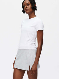 Model wearing Warmup 2.5" Skort in Heather Gray, featuring a stylish split hem for active movement.