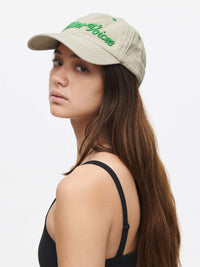Profile view of a woman wearing a Washed Hat with Outdoor Voices signature.