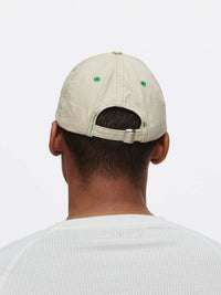 Back view of a man wearing a Washed Hat with topstitching in raised Outdoor Voices signature.