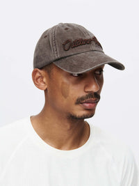 Model wearing Washed Hat in Gray, featuring Outdoor Voices signature topstitching.