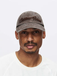 Model wearing Washed Hat in Gray, featuring Outdoor Voices signature topstitching for everyday wear.