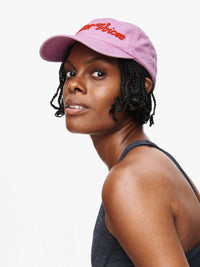 Model wearing Washed Hat in Lavender, featuring raised lettering and a curved brim.