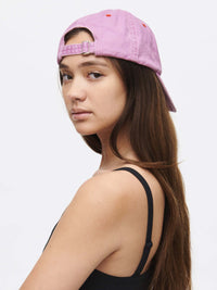 Model wearing Washed Hat in Lavender, with the relaxed fit and adjustable strap.