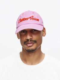 Model wearing Washed Hat in Pink, featuring raised signature text and a relaxed fit.