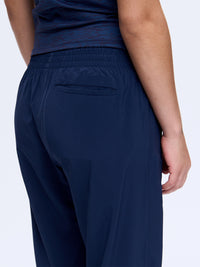 Back view of Zephyr 26" Pant in Navy, featuring a zippered pocket and breathable fabric for everyday wear.