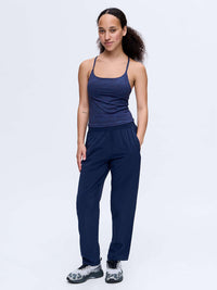 Model standing in Zephyr 26" Pant in Navy, featuring zippered pockets and a custom-fit drawstring waist.