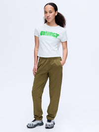 Model standing in Zephyr 29" Pant in Olive, featuring a custom-fit drawstring waist for comfort.