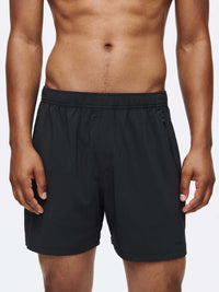 Model wearing Zephyr 5" Short in Black, featuring zippered pockets and breathable fabric.