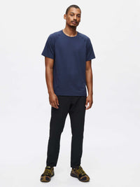 Model standing in Zephyr Pant in Black, with the lightweight fabric and drawstring waist for active performance.