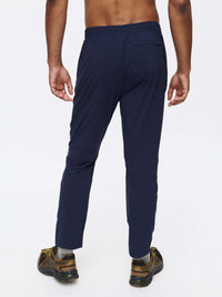 Back view of Zephyr Pant in Navy, featuring a custom-fit drawstring waist and zippered pockets for daily wear.